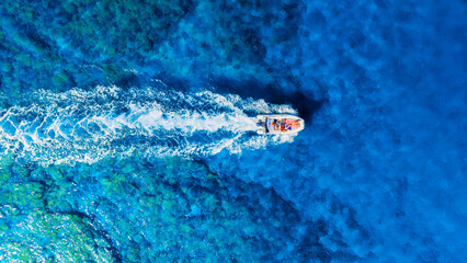 Wall Mural - a fast boat on an azure sea. clear turquoise water and a boat. view from the air. summer landscape f