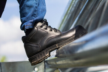 Wall Mural - Wear safety shoes to ensure safety at work. construction workers wear safety shoes. People with factory safety concept