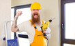 © kues1 - red hair man feeling shocked,laughing and celebrating success repairing home. handyman concept
