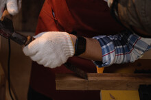 Carpenter Hand With Chisel In Hand Working On Carpentry. Carpenter Use Wood Chisels To Make Wooden Products In The Workshop. Soft Focus Close-up On A Chiseling At Mark.