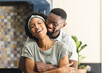 © WavebreakMediaMicro - Portrait of happy african american couple embracing and laughing in kitchen