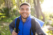 © Wavebreak Media - Portrait of happy biracial man looking at camera and smiling in forest, unaltered