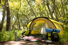 General View Of Tent With Backpack And Hiking Equipment In Forest, Unaltered