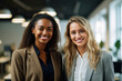 © Cavan Images - Two smiling young workers standing in the office looking camera, Generative AI