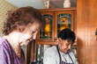 © Cavan Images - two senior female friends cooking together in the kitchen