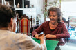 © Cavan Images - two happy senior female friends playing board games