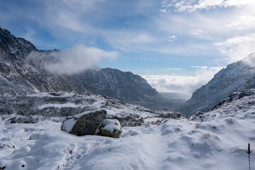 Wall Mural - Panorama of Mountaineer standing on top of snowy mountain range at High Tatras, Slovakia