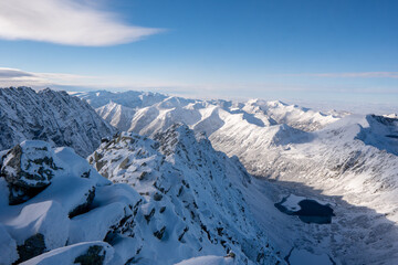 Wall Mural - Panorama of Mountaineer standing on top of snowy mountain range at High Tatras, Slovakia