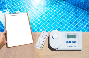 Wall Mural - Digital swimming pool water tester with blank clipboard in girl hand over clear pool water background, swimming pool service and maintenance, report and check list, quality tester equipment