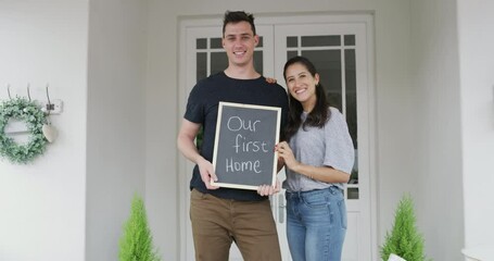 Wall Mural - Portrait, property and a homeowner couple with a chalkboard for an announcement of their purchase together. Love, happy or smile with a man and woman looking proud of their real estate investment