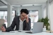 © Natee Meepian - Tired exhausted business man office worker sitting at his desk tired of working in a laptop, overworked, having a headache, closed his eyes, needs rest and break