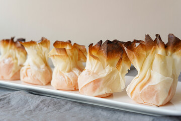 Wall Mural - Traditional Portuguese sweets with egg cream - tulhinhas on the kitchen table