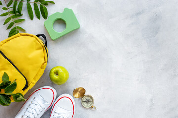 Flatlay with hiking backpack and sneakers. Summer camp concept