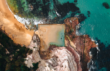 Wall Mural - aerial drone shot of aslings beach rock pool in eden, new south wales, australia.
