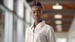 Young African American female handsome transgender person looking at camera in office, non-binary gender, stylish formal clothes, pastel colors, business modern concept, AI Generated.