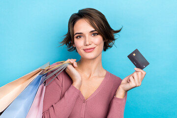 Photo of young bob brown hair girl wear pink shirt hold plastic debit card already purchased bags clothes isolated on blue color background