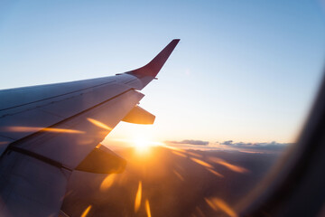 Canvas Print - Looking at the sunset through the airplane window