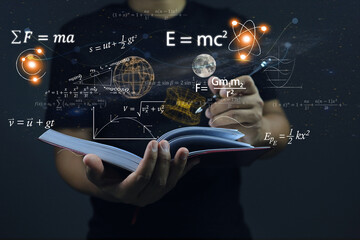 Hands writing in notebooks on dark the background physics and math equations floating on the background, representing the learning teaching or scientific notes of Albert Einstein and Sir Isaac Newton.