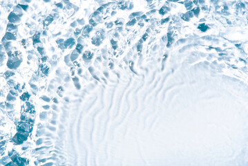 Wall Mural - The texture of water on a white background in bright sunlight.
