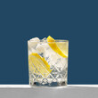 Gin tonic cocktail on the white podium. Summer cocktail. Gin tonic classic alcoholic cocktail drink with dry gin, bitter tonic, lemon and ice.