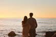 © Emil L/peopleimages.com - Hug, sunset and couple relax on beach in evening on holiday, summer vacation and weekend by ocean. Nature, love and man and woman embrace, hugging and calm for bonding, quality time and peace by sea