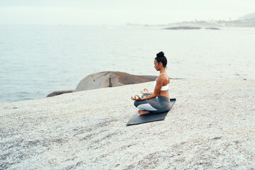 Canvas Print - Yoga, meditation and woman on a beach with lotus pose, wellness and fitness. Pilates, sea and female person on sand with peace in nature feeling relax and calm with spiritual and holistic mockup