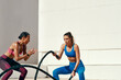 © Emil Lime/peopleimages.com - Woman, personal trainer and battle rope for exercise, workout or training in fitness outdoors. Active or serious coach with female person exercising with ropes for sports motivation on mockup space