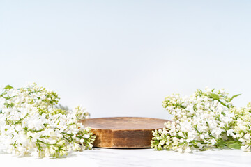 Canvas Print - Cosmetics skin care product presentation stage display made with wooden podium and blossom branch on white background. Studio photography.