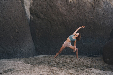 Wall Mural - Woman is practicing yoga on the beach.