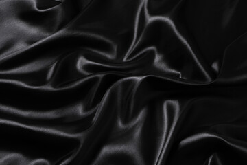 Silk fabric, abstract wavy black satin fabric background.