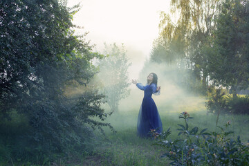 Canvas Print - young beautiful woman in blue vintage dress in magic forest