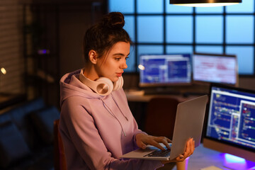 Wall Mural - Young female programmer working in office