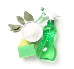 Bowl of baking soda, sprayer, cleaning sponges and eucalyptus branch on white background