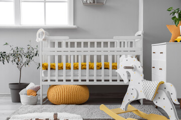 Sticker - Baby crib in interior of light bedroom