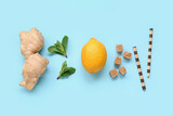Fototapeta Kawa jest smaczna - Lemon with mint, ginger and straws on blue background