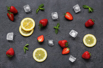 Fresh strawberries with lemon and ice cubes on black background