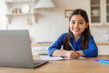 Girl Taking Notes At Laptop Embracing E-Learning, Studying From Home