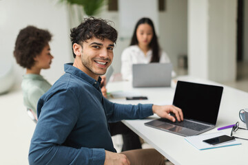 Middle Eastern Businessman Using Laptop Sitting At Meeting In Office