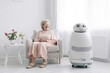 © Goffkein - Robot caregiver takes care and looks after an elderly retired old woman at home created with Generative AI