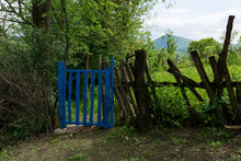 Vintage Fence On A Rural Estate With Freshly Painted Blue Garden Gates On A Spring Day In The Countryside