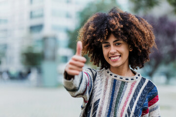 Wall Mural - young African American woman portrait in city of Latin America, Hispanic and caribbean people with afro hair on winter and cold weather