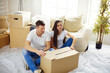 © lenets_tan - Happy young couple unpacking or packing boxes and moving into a new home