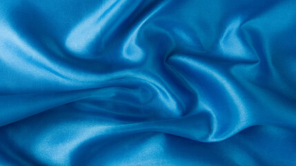 Abstract blue silk fabric texture background. Creases of satin	
