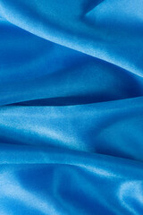 Abstract blue silk fabric texture background. Creases of satin	
