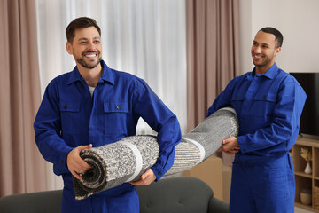 Wall Mural - Male movers carrying carpet in new house