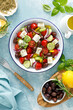 Greek salad. Vegetable salad with feta cheese, tomato, olives, cucumber, red onion and olive oil. Healthy vegetarian mediterranean diet food. Top view