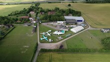 Aerial View Orbiting De Havilland Mosquito And Vampire Preserved Aircraft Collection Outside Historical Hertfordshire Museum