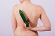 © Ivan Zelenin - Close up portrait of attractive young woman topless with cucumber in studio