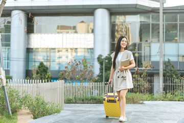 Freelance young asian woman walking with travel luggage for business trip