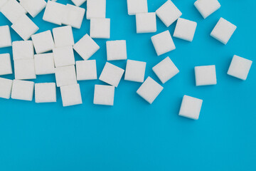 Wall Mural - Sugar cubes on blue background